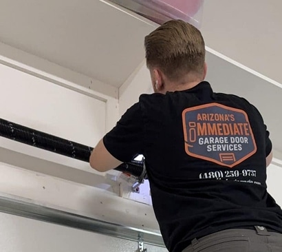 technician fixing garage door in an AZ home